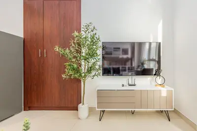 a bathroom with a sink and a potted plant at Studio Near Dubai Water Canal and Bus Station, Conveniently Close to Downtown, The Scala Tower, Business Bay by Deluxe Holiday Homes in Dubai