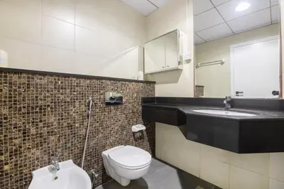 a bathroom with a toilet and a sink at Luxury 2BHK in Jumeirah Lakes Towers Icon 3502 in Dubai