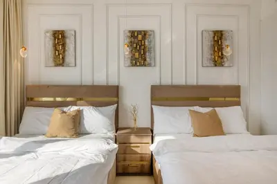 two beds sitting next to each other in a bedroom at Luxury 2BHK in Jumeirah Lakes Towers Icon 3502 in Dubai