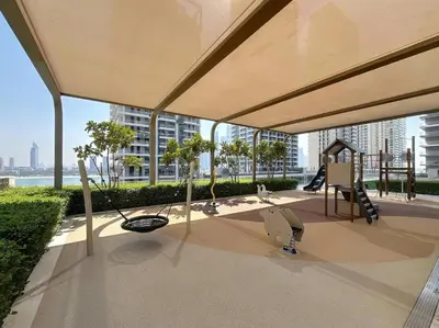 a playground on a building with a view of a city at Beachfront 2BR Grand Bleu Luxe Near Dubai Palm & Marina Hotspots in Dubai