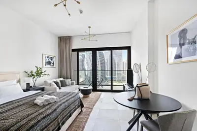 a bedroom with a bed and a table and a couch at Apartment with Burj Khalifa, Canal View with Big Balcony in Dubai