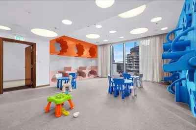 a room with blue chairs and a climbing wall at FIRST CLASS 4BR Luxe Downtown Escape in Dubai