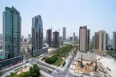 an aerial view of a city with tall buildings at Homes & Beyond l Serene 1BR Retreat in JVC in Dubai