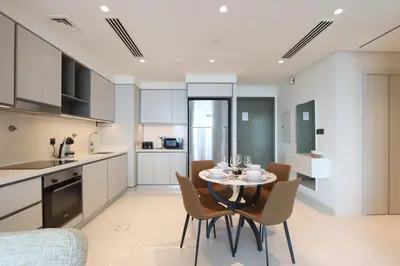 a kitchen and dining room with a table and chairs at Elegant 2BR with Dubai Marina Skyline & Sunset Views in Dubai