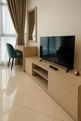 a living room with a flat screen tv on a entertainment center at Happy Dom Palm in Dubai