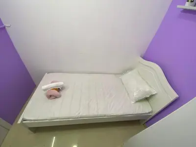 a small white bed with a stuffed animal on it at Elegant Partition Room Al Barsha 1 in Dubai