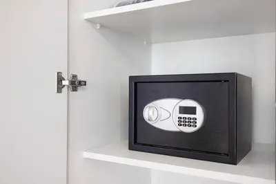 a black and white clock on a shelf next to a door at Elegant Stay with Pool & Gym Near Iconic Landmarks in Dubai