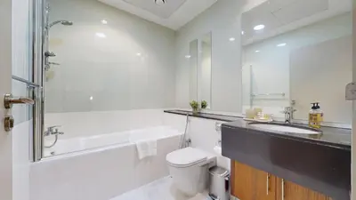 a bathroom with a sink and a toilet and a tub at Marina Heights 1 - Opulent One Bedroom in Marina in Dubai