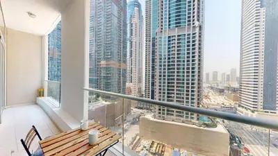 a balcony with a table and a view of a city at Marina Heights 1 - Opulent One Bedroom in Marina in Dubai