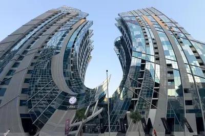 two tall glass buildings in a city at Modern Studio Steps from Iconic Dubai Mall & World-Class Amenities in Dubai