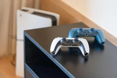 two video game controllers sitting on top of a table at Stunning 4BR with Burj Khalifa and Fountain View, Downtown Dubai in Dubai