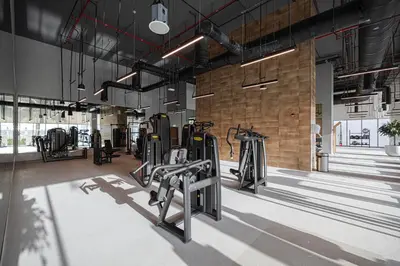 a gym with several treadmills and ellipticals at Stunning 4BR with Burj Khalifa and Fountain View, Downtown Dubai in Dubai