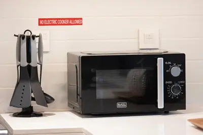 a microwave oven sitting on a counter with a spatula at Stunning 4BR with Burj Khalifa and Fountain View, Downtown Dubai in Dubai
