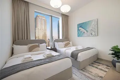 a hotel room with two beds and a window at Stunning 4BR with Burj Khalifa and Fountain View, Downtown Dubai in Dubai