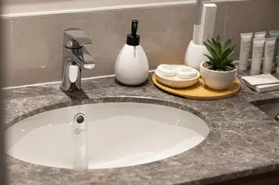 a sink with a faucet and two soap dishes at Stunning 4BR with Burj Khalifa and Fountain View, Downtown Dubai in Dubai