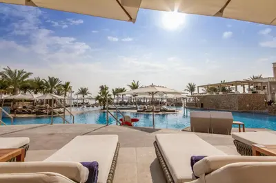 a view of the pool at the resort at Bespoke Holiday Homes - Spacious 2BR Luxury Apartment with Stunning Palm Views, Balqis in Dubai