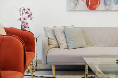 a living room with a couch and two chairs at Neat and Cozy 2BR plus Kids Room - 7min to Dubai Mall in Dubai