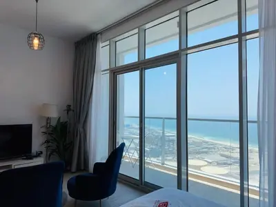 a room with a large window with a view of an airport at Sophisticated Fully Furnished and Family-Friendly in Dubai