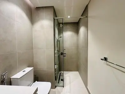 a bathroom with a shower and a toilet and a sink at Sophisticated Fully Furnished and Family-Friendly in Dubai
