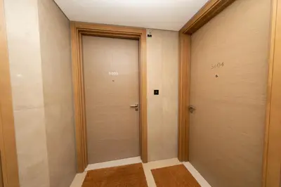 a corridor with two doors in a room at Modern Living with Skyline Views in Hartland in Dubai