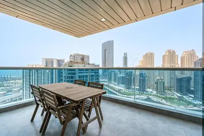 a dining room with a view of the city at 2BR with Marina Views - Near JBR Beach & Dubai Eye in Dubai
