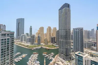 a view of a city with boats in a harbor at 2BR with Marina Views - Near JBR Beach & Dubai Eye in Dubai