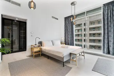 a bedroom with a bed and a large window at 2BR with Marina Views - Near JBR Beach & Dubai Eye in Dubai