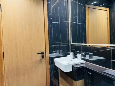 a bathroom with two sinks and a mirror at Private Pool II Spacious II Brand New in Dubai