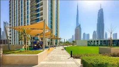a park in a city with tall buildings at Zabeel View I Fully Furnished I Prime Location in Dubai