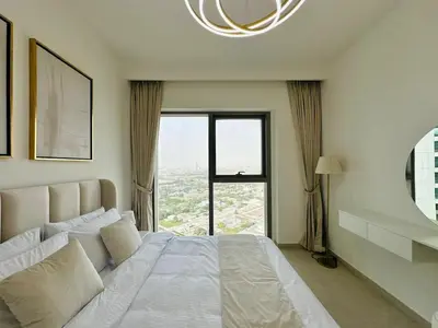 a bedroom with a large bed with a large window at Zabeel View I Fully Furnished I Prime Location in Dubai