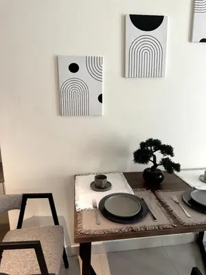 a table with two plates and a tree on it at Best Canal View Studio in AG Tower Business Bay in Sabkhah