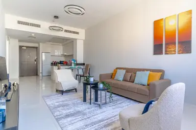 a living room with a couch and a table at The Smart Concierge - Damac 108 in Dubai