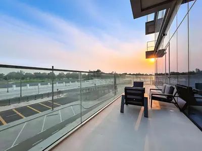 a balcony with a table and chairs and a view of a highway at Jumeirah Waterfront Residences in Dubai