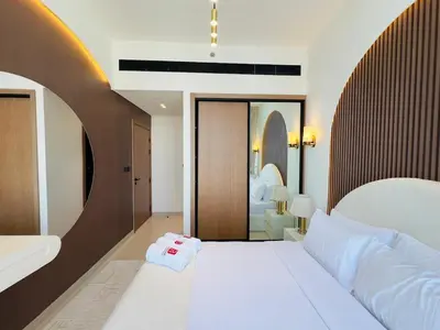 a bedroom with a large white bed and a mirror at High-End Furnished Homey Elegant with Private Pool in Dubai
