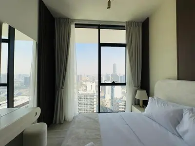 a hotel room with a bed and a large window at High-End Furnished Homey Elegant with Private Pool in Dubai