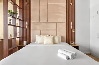 a bedroom with a white bed with towels on it at Stylish Furnished Apartment with Burj Khalifa View, High Floor in Dubai