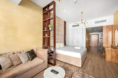 a living room with a bed and a couch at Stylish Furnished Apartment with Burj Khalifa View, High Floor in Dubai