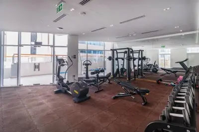 a gym with several treadmills and exercise bikes at Stylish Furnished Apartment with Burj Khalifa View, High Floor in Dubai