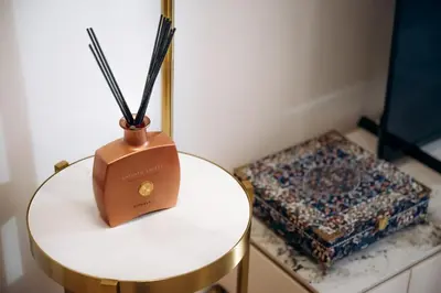 a table with a vase on it next to a box at Luxurious Apartment in the Heart of Dubai in Dubai