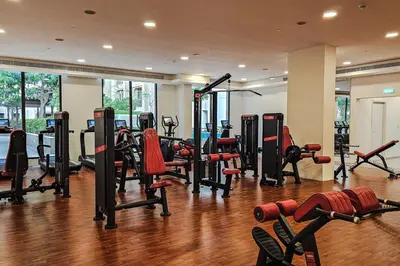 a gym with a bunch of equipment in a room at Luxurious Apartment in the Heart of Dubai in Dubai