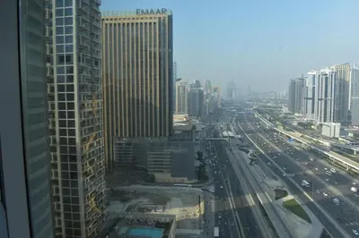a view of a city with buildings and freeway at Cozy 2BR -Near JBR Beach &Metro in Dubai