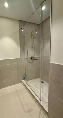 a shower with a glass door in a bathroom at Giramondo Forte Tower 1 in Dubai