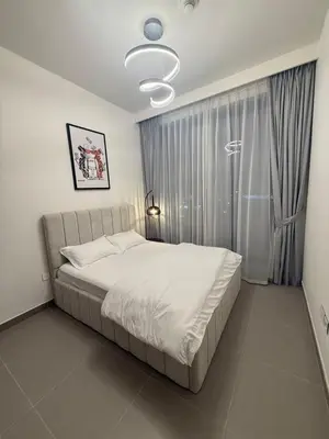 a bedroom with a bed and a large window at Giramondo Forte Tower 1 in Dubai