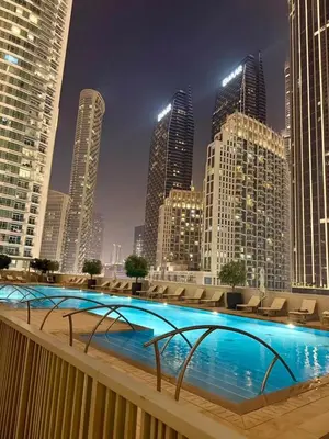 a large swimming pool in a city with tall buildings at Giramondo Forte Tower 1 in Dubai