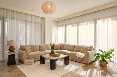 a living room with a couch and a table at Seraya Residence 20 - 4BDR - Burj View with direct access to Dubai Mall in Dubai
