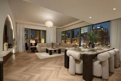a living room with a table and a couch at Seraya Residence 20 - 4BDR - Burj View with direct access to Dubai Mall in Dubai