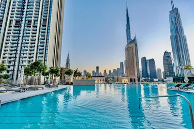 a swimming pool in a city with tall buildings at Seraya Residence 20 - 4BDR - Burj View with direct access to Dubai Mall in Dubai