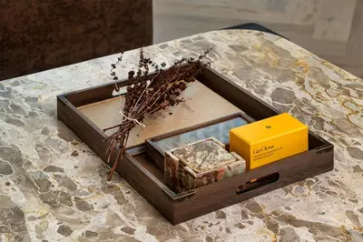 a wooden box sitting on top of a table at Seraya Residence 21 - 4BDR - Cozy terrace with Burj Views in Dubai