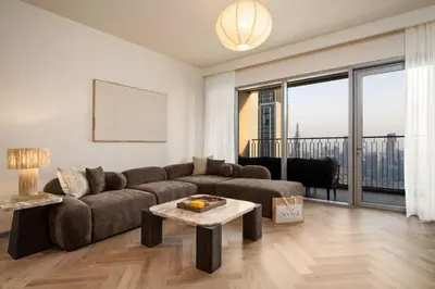 a living room with a couch and a table at Seraya Residence 21 - 4BDR - Cozy terrace with Burj Views in Dubai
