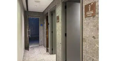 a hallway of a building with two doors and a sign at Stylish Studio - 5-min walk Burj Khalifa & Dubai Mall in Dubai